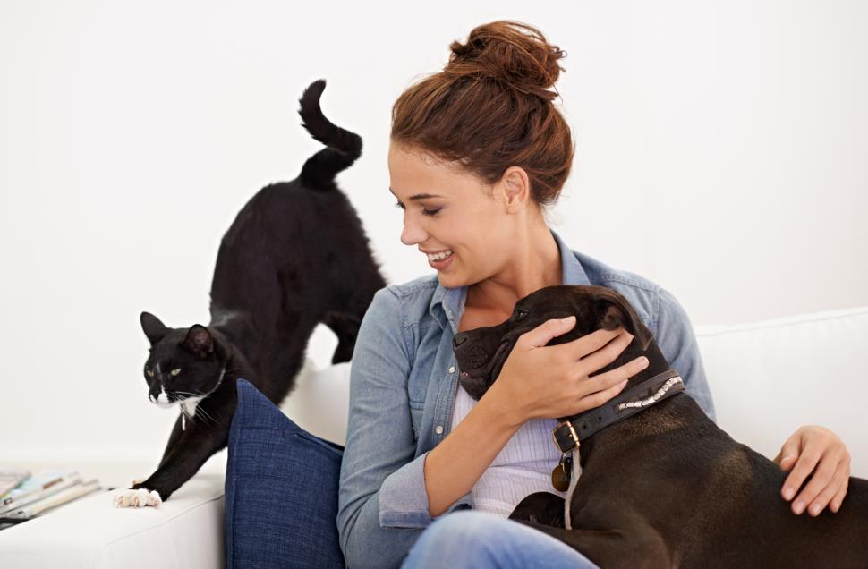 Woman loving her dog and cat